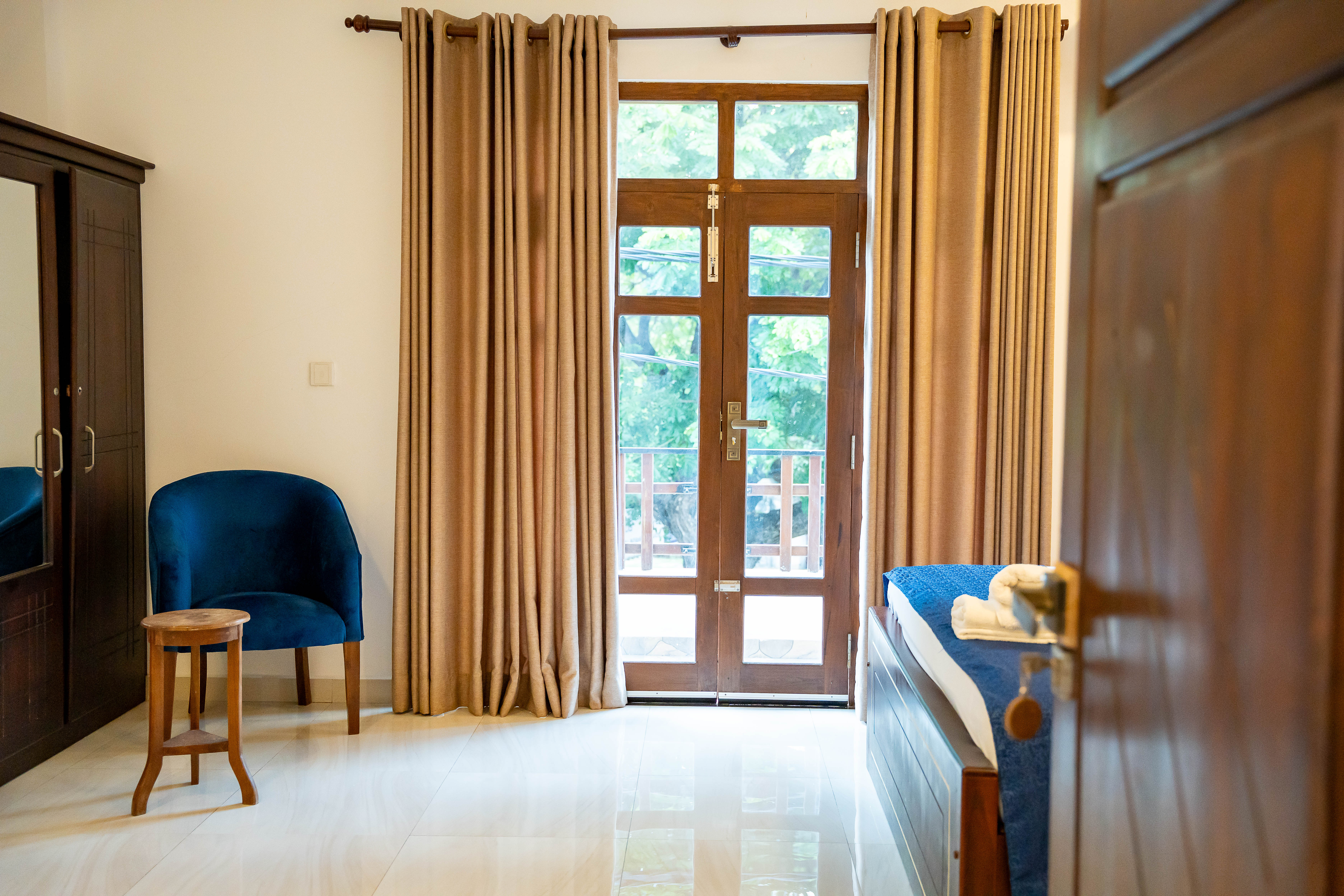 Room balcony door opening to coastal breeze